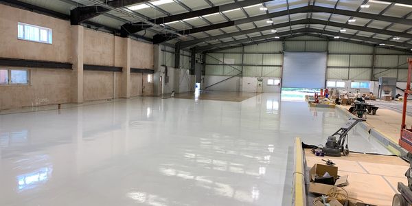 Polished white industrial resin flooring installed by UP Group.