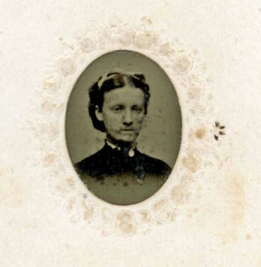 Historical photo of a young woman with her hair up.