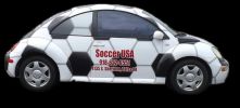 Car painted like a soccer ball with advertising text.