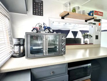 Countertop with toaster oven, coffee maker, and microwave.