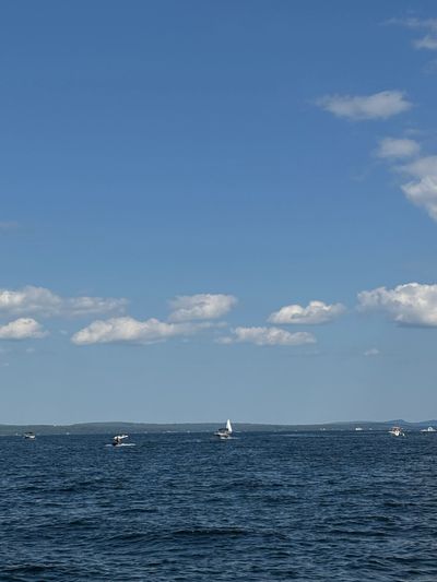 Boats sailing on a calm sea under a clear sky.