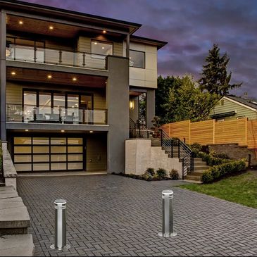 modern house with three automatic bollards in the driveway