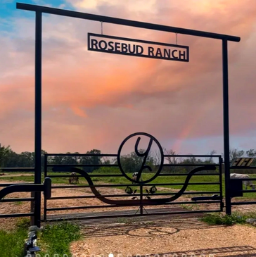 Steel gate on a ranch with tall crossbeam