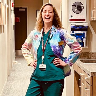 Happy healthcare worker in colorful jacket.