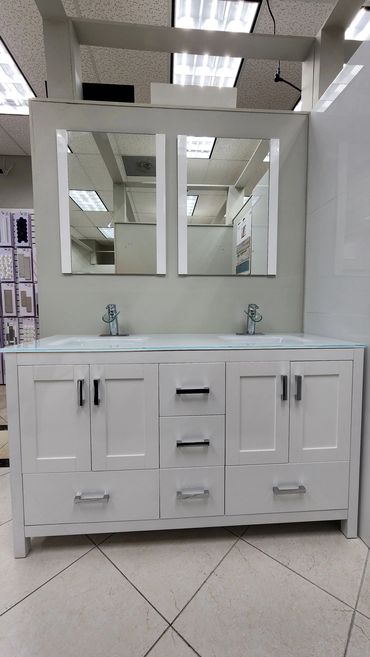 White double sink bathroom vanity with mirrors and storage cabinets.