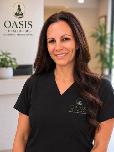 Smiling woman in black scrubs at Oasis Health Hub.