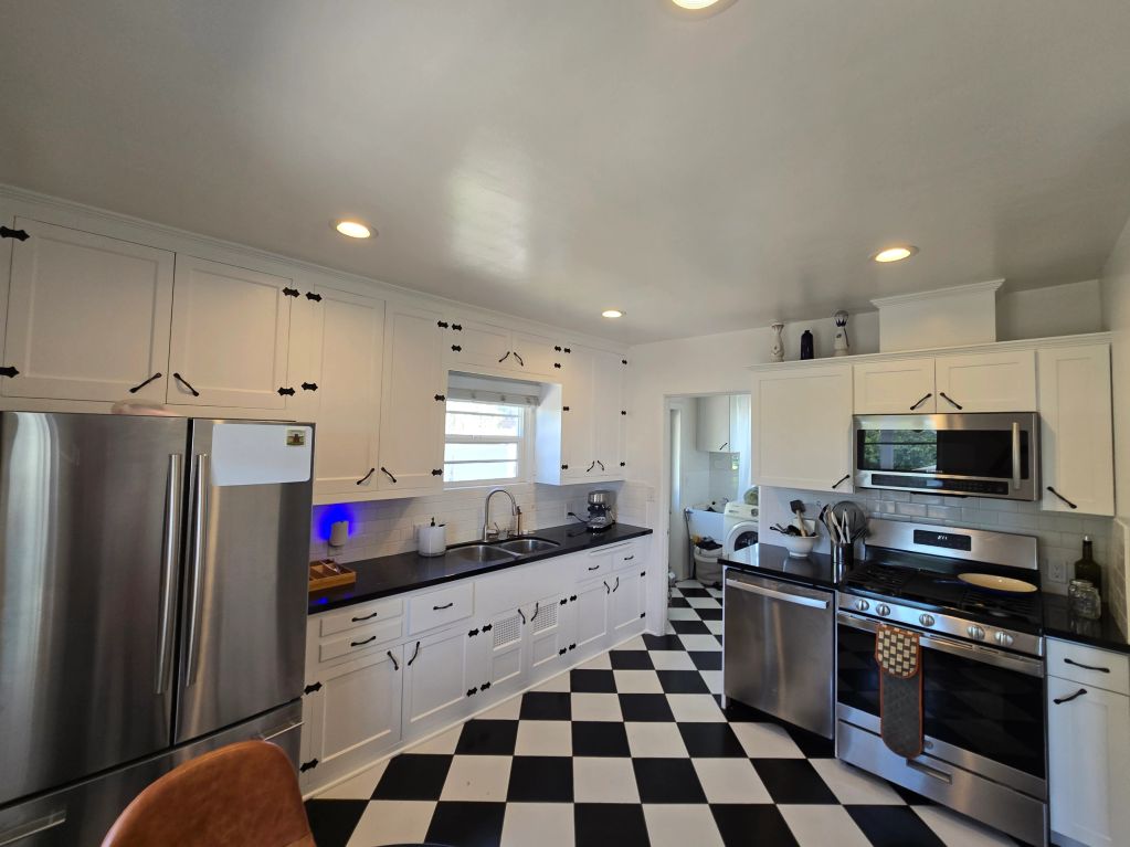Modern kitchen with black and white checkered floor.