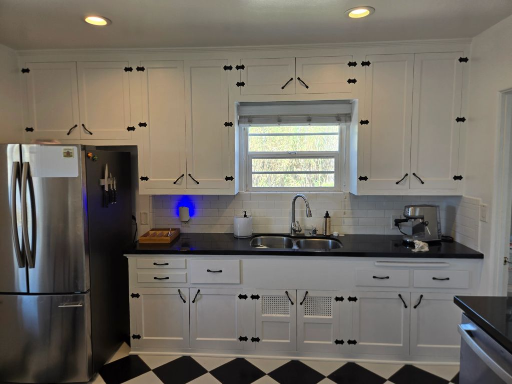 White kitchen cabinets with black hardware.