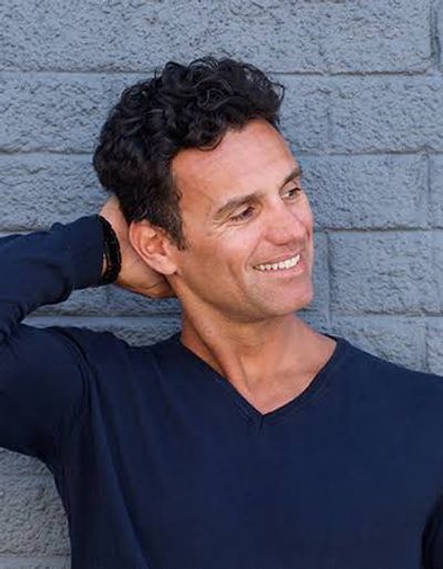 Smiling male client with clear, healthy skin after receiving men's aesthetic and skincare treatments