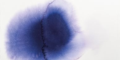 Abstract dark blue watercolor blot on white background.
