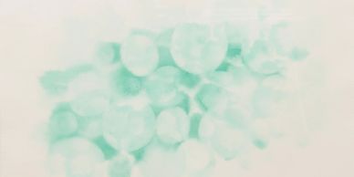 Blurred cluster of green spheres on a white background.