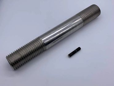 Two metal threaded rods of different sizes on a white surface.