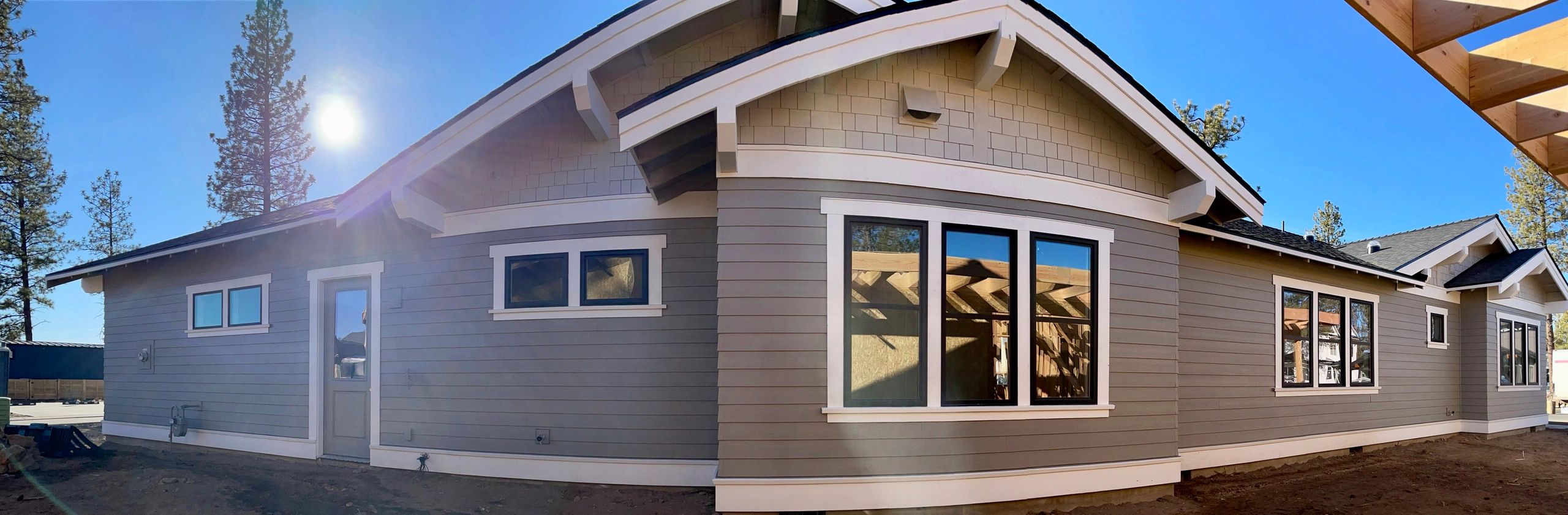 Wide view of a newly sided custom home in Bend, Oregon completed by Elite Construction Contracting