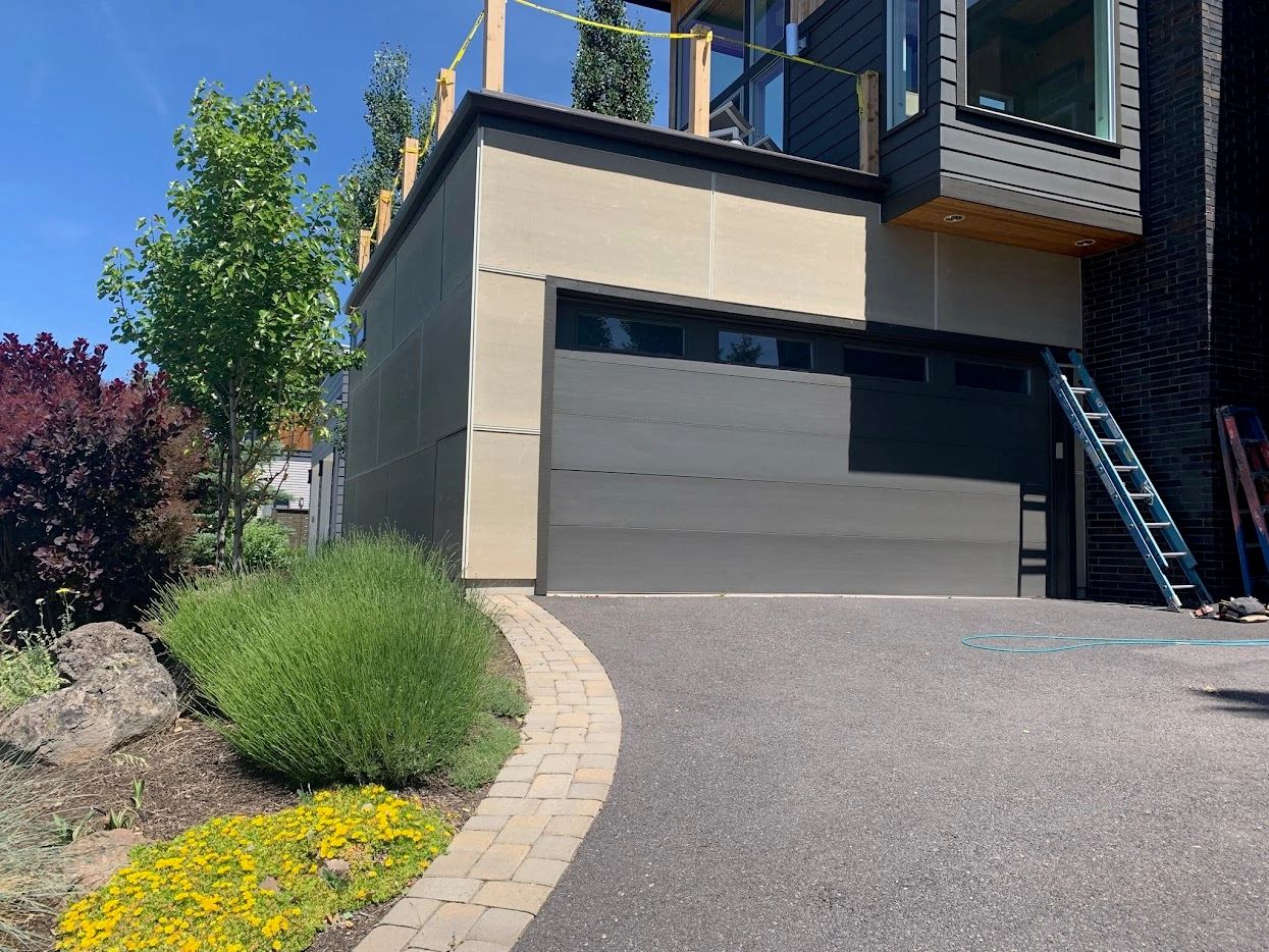 Modern panel siding and garage on a westside Bend, Oregon home resided by Elite Construction Contracting