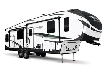 Modern fifth-wheel RV trailer with sleek design and dual axles.