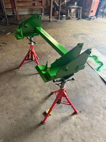 Green metal frame on red adjustable stands.