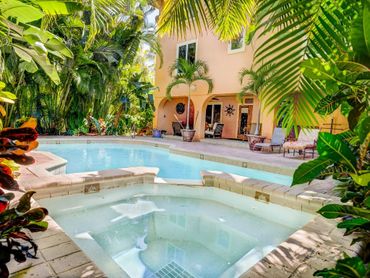 Private oasis with a heated pool, hot tub, and professional tropical landscaping