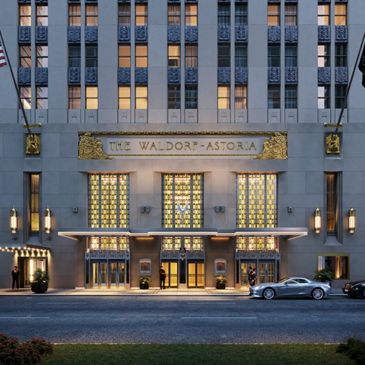 Entrance of The Waldorf Astoria hotel at dusk.