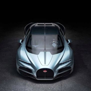 Front view of a sleek Bugatti sports car in metallic blue.