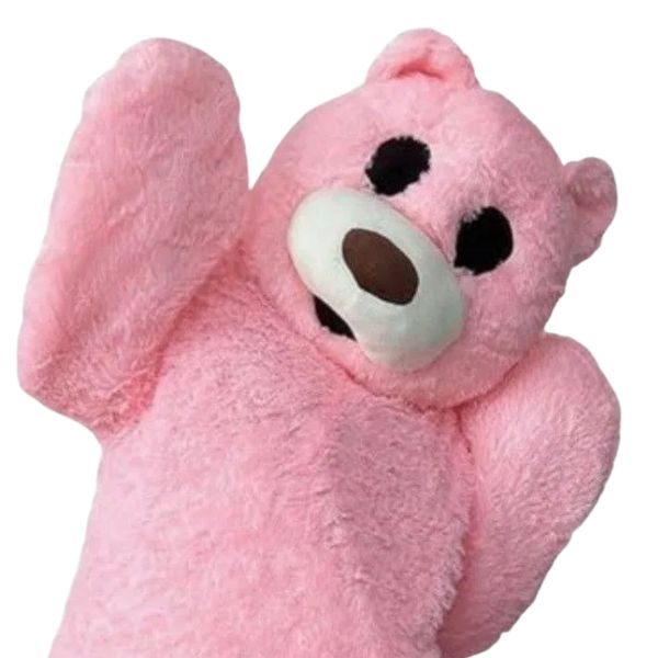 Close-up of a pink teddy bear with raised arms.
