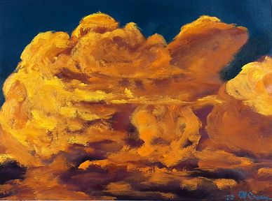 Golden clouds glowing against a deep blue sky.
