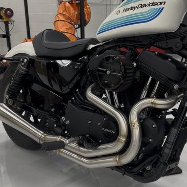 Close-up of a Harley-Davidson motorcycle's engine and exhaust system.