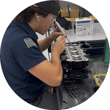 Technician inspecting an engine component with precision tools.