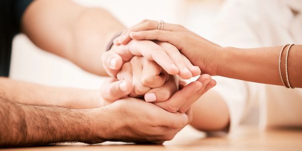 Family holding hands in therapy
