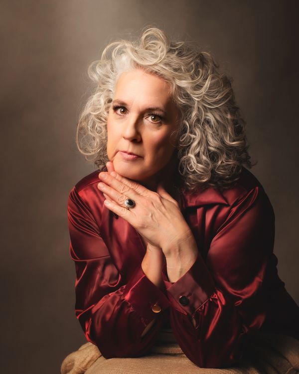 Glamour portrait of a white haired woman in a red dress