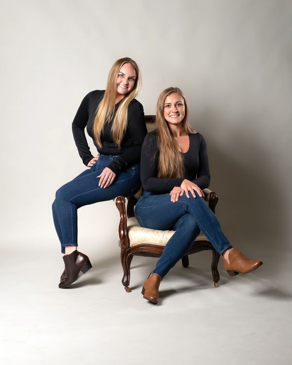 Portrait of two sisters sitting on a chair
