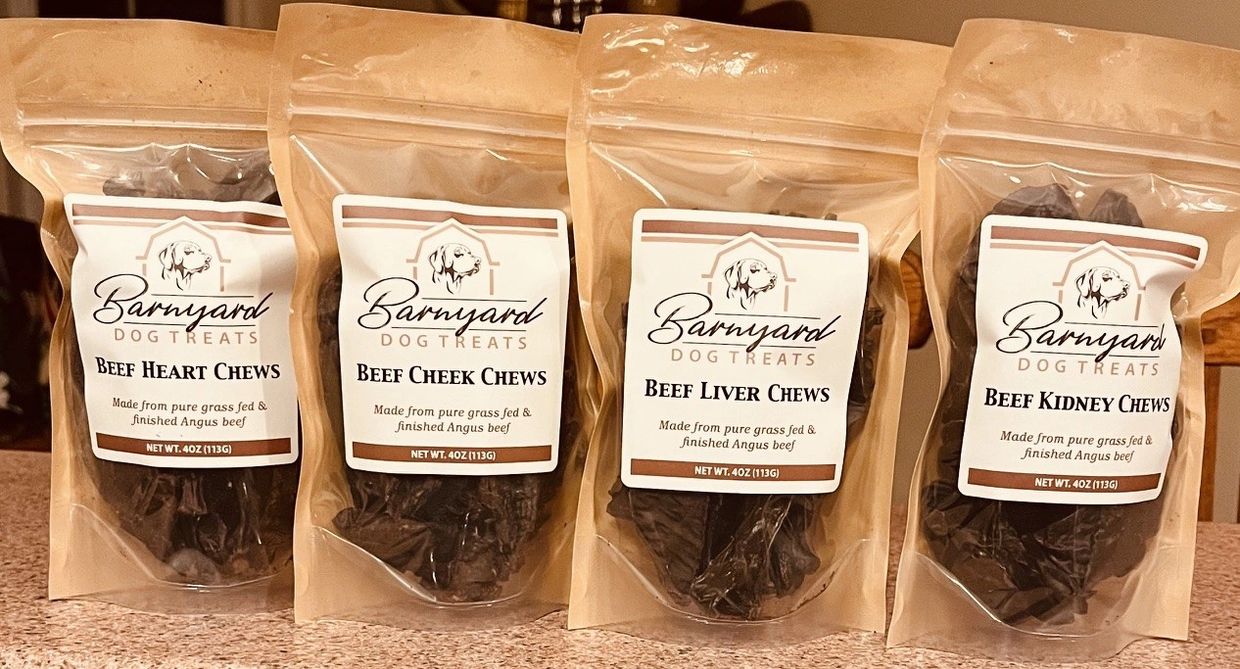 Four bags of Barnyard dog treats with different beef chews.