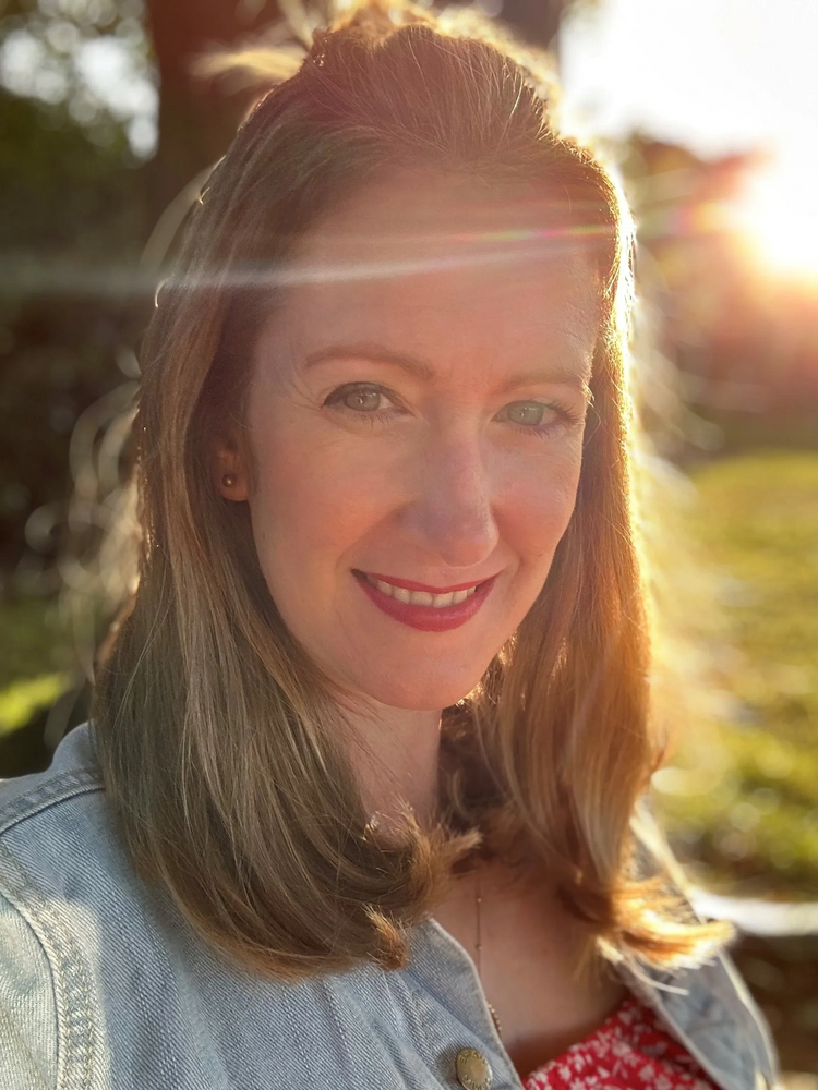 Portrait photo of Emma Sheppard with sunshine behind her