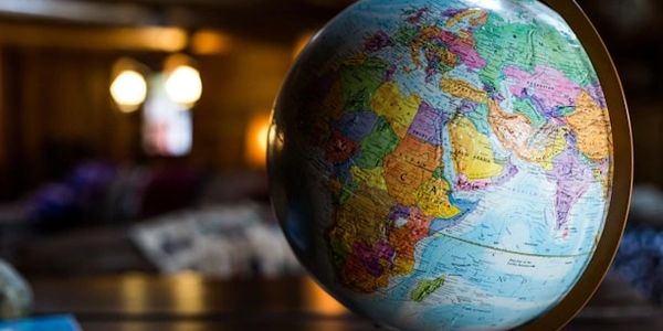 A colorful globe showing Africa, Europe, and Asia with a blurred background.