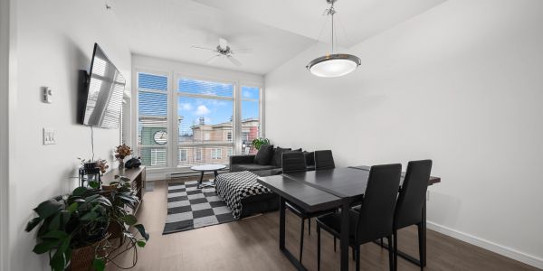 Minimalist living-dining room with black furniture and large window.