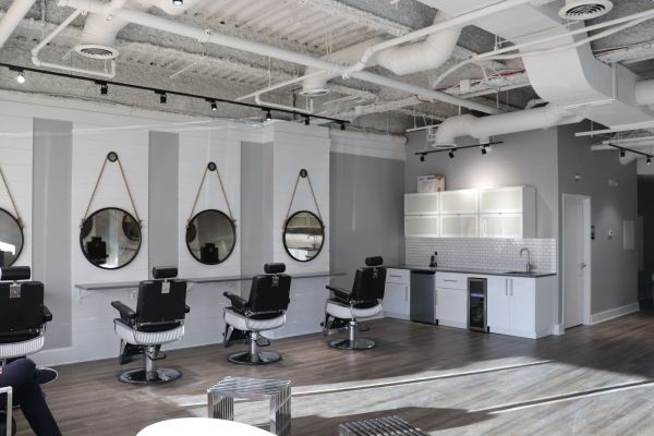 Modern barbershop interior with chairs and mirrors.