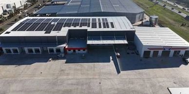 Industrial building with solar panels on the roof.
