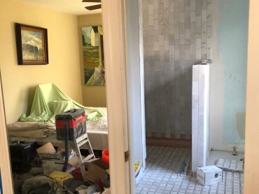 Interior of a home under renovation with construction tools and materials.