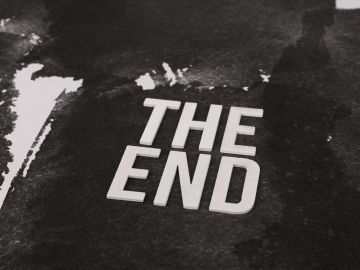 Words "THE END" on a dark textured background.