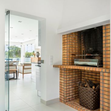 Modern kitchen with brick fireplace and glass door.