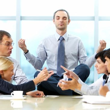 Corporate Wellness with man meditating on desk - Bringing Health and Fitness to Your Business.