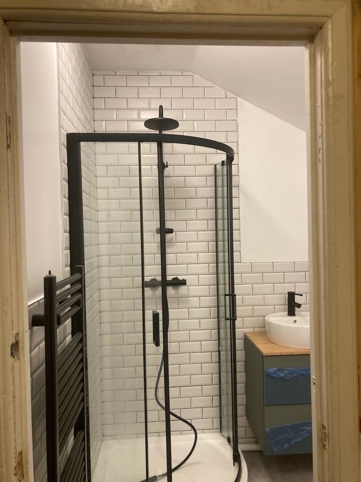 Black shower enclosure with metro tiles and black grout fitted in Bolton