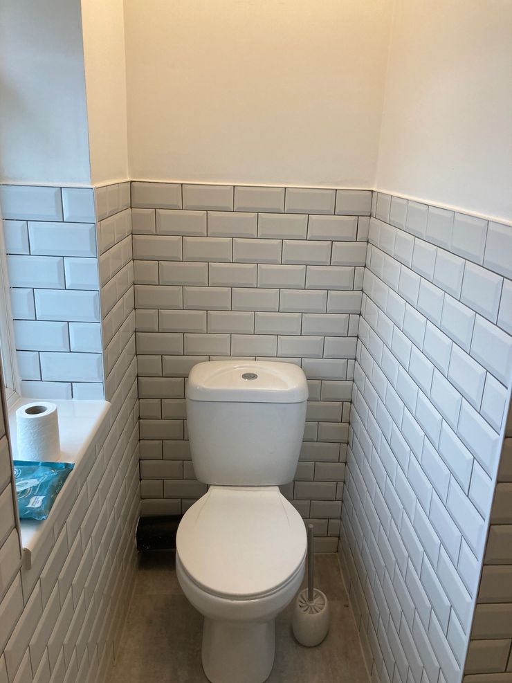 Metro tile bathroom with black accessories completed in Greater Manchester