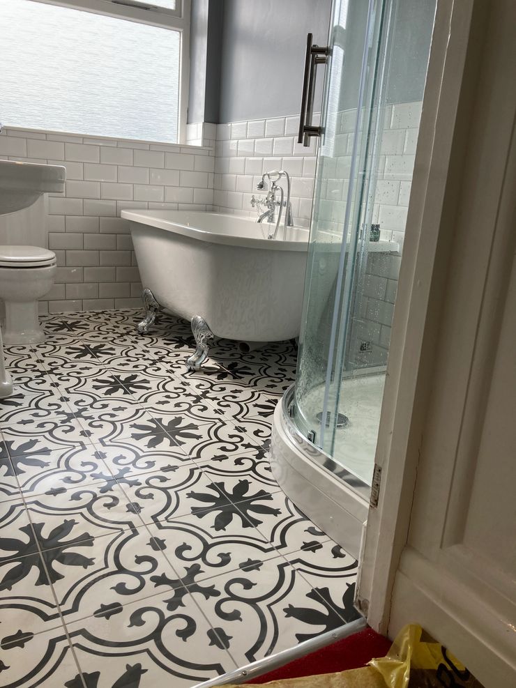Traditional bathroom with freestanding bath and floor-mounted taps in Manchester