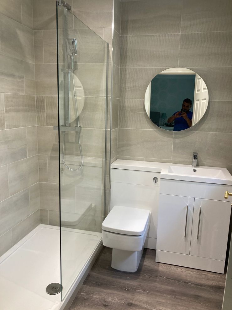 Bathroom installation with heated towel rail and new tiling in Bolton