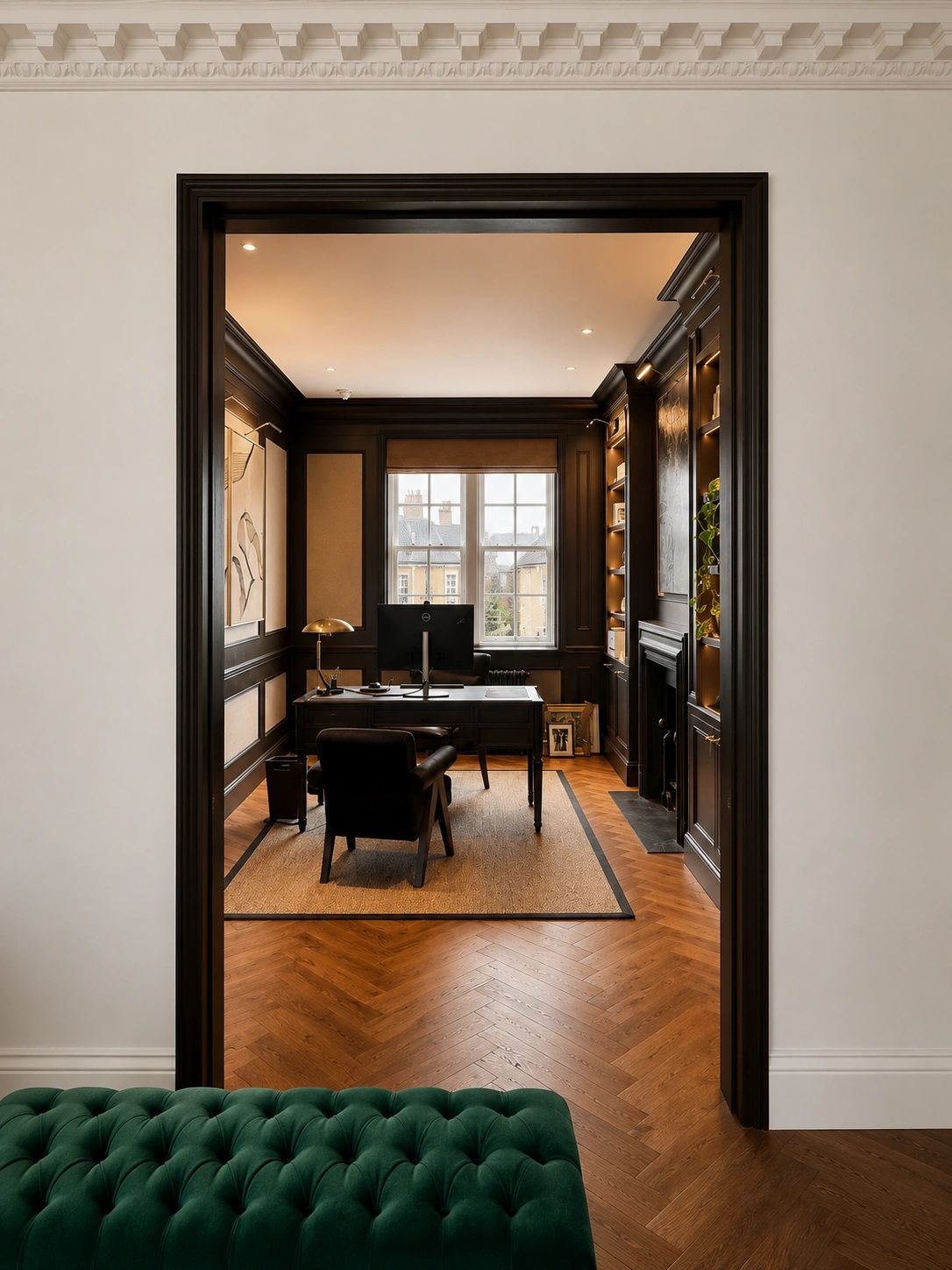 Elegant home office with dark wood paneling and large window.