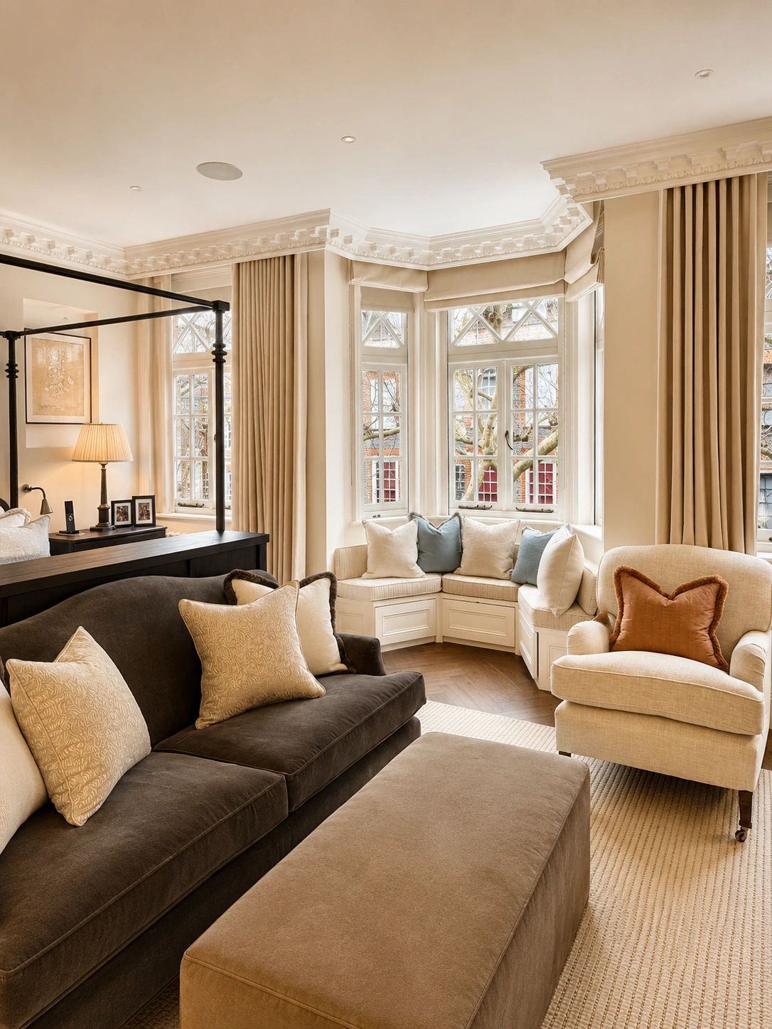 Elegant living room with plush seating and large bay windows.