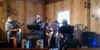 A music group on stage at Little Creek Opry House