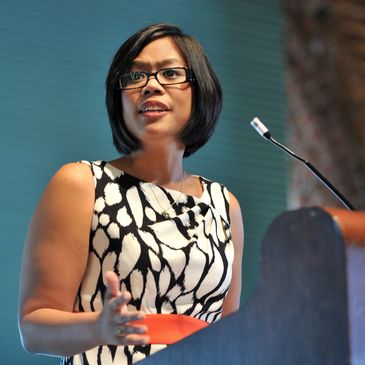 woman at podium Monina Wagner photo credit Wetzler Studios