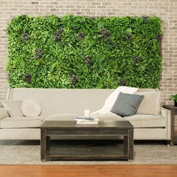 Living room with vertical garden on the wall.