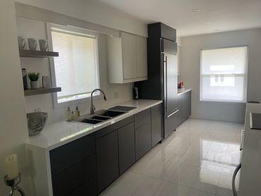 Modern Galley Style Kitchen with Custom Cabinets and Waterfall Countertops
